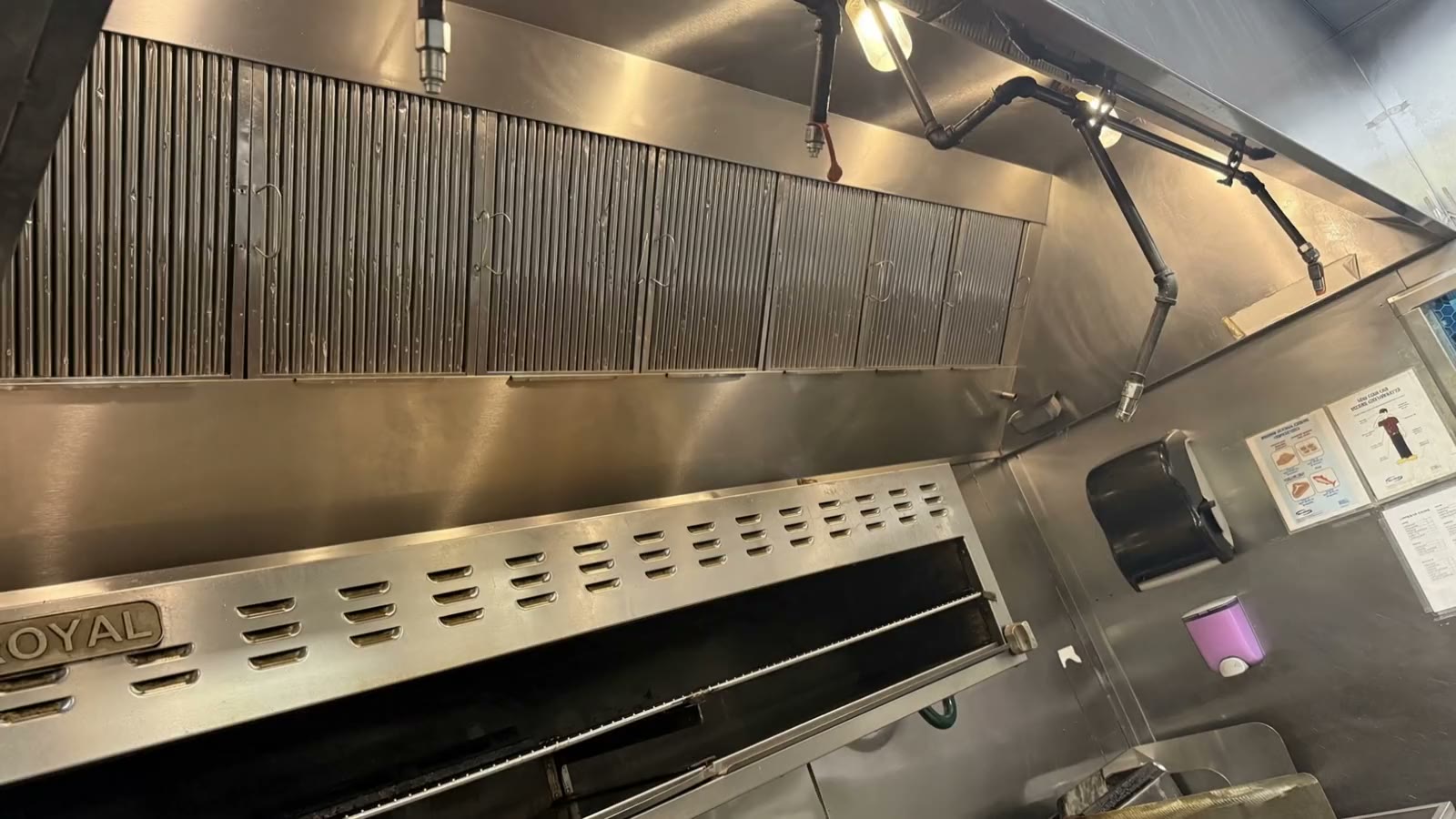 A freshly cleaned stainless steel restaurant exhaust hood